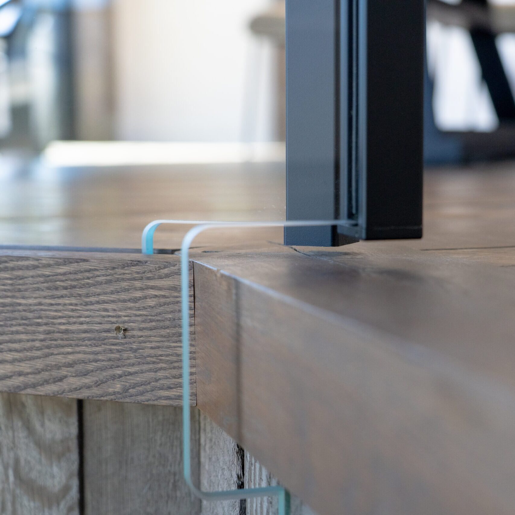 Close up view of Viewrail custom glass cut to go around a flooring edge.