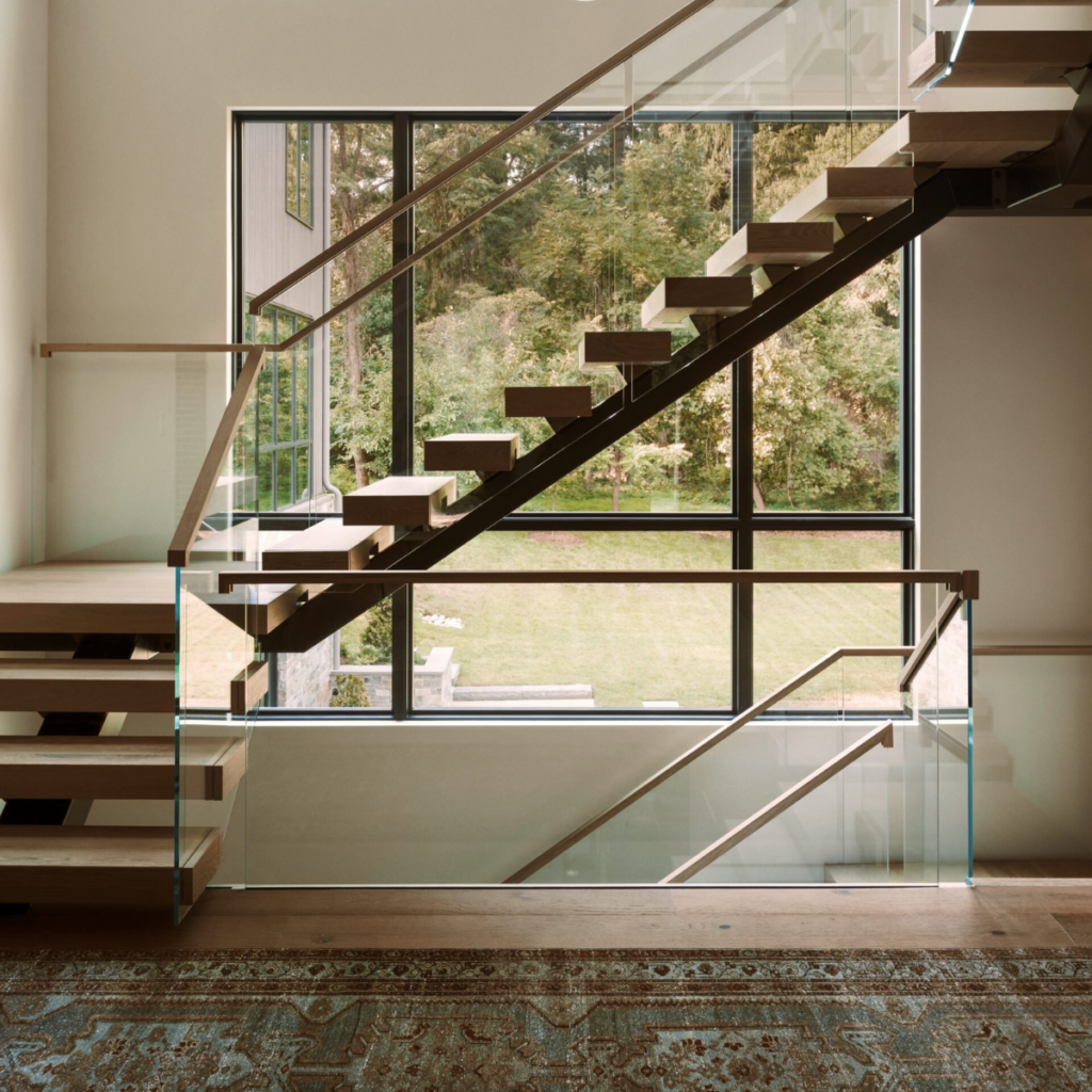 A multi-story Viewrail glass project with U-shaped stairs and a hidden side mount railing to transition between staircases.
