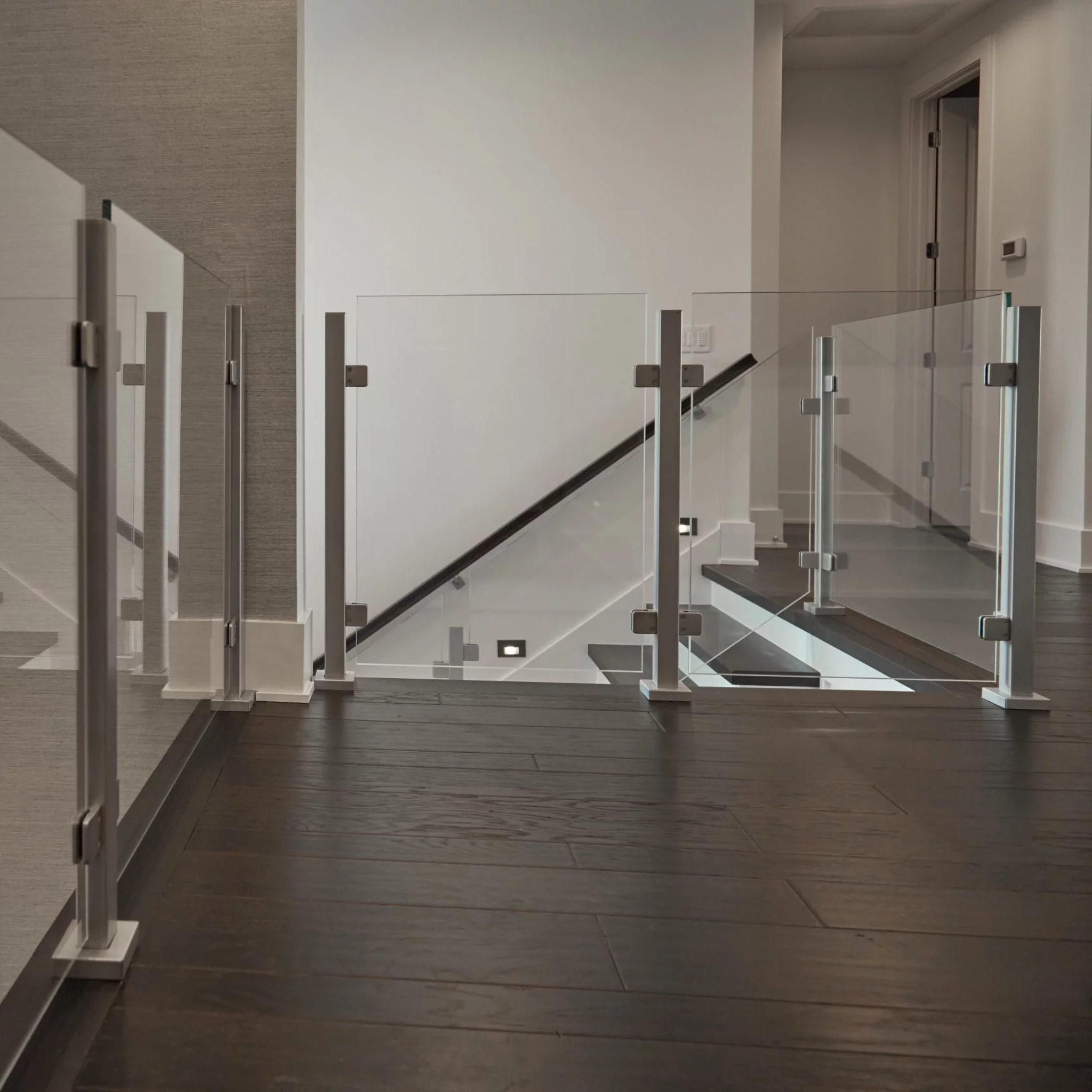 Barrier Glass on a second floor landing next to stairs.