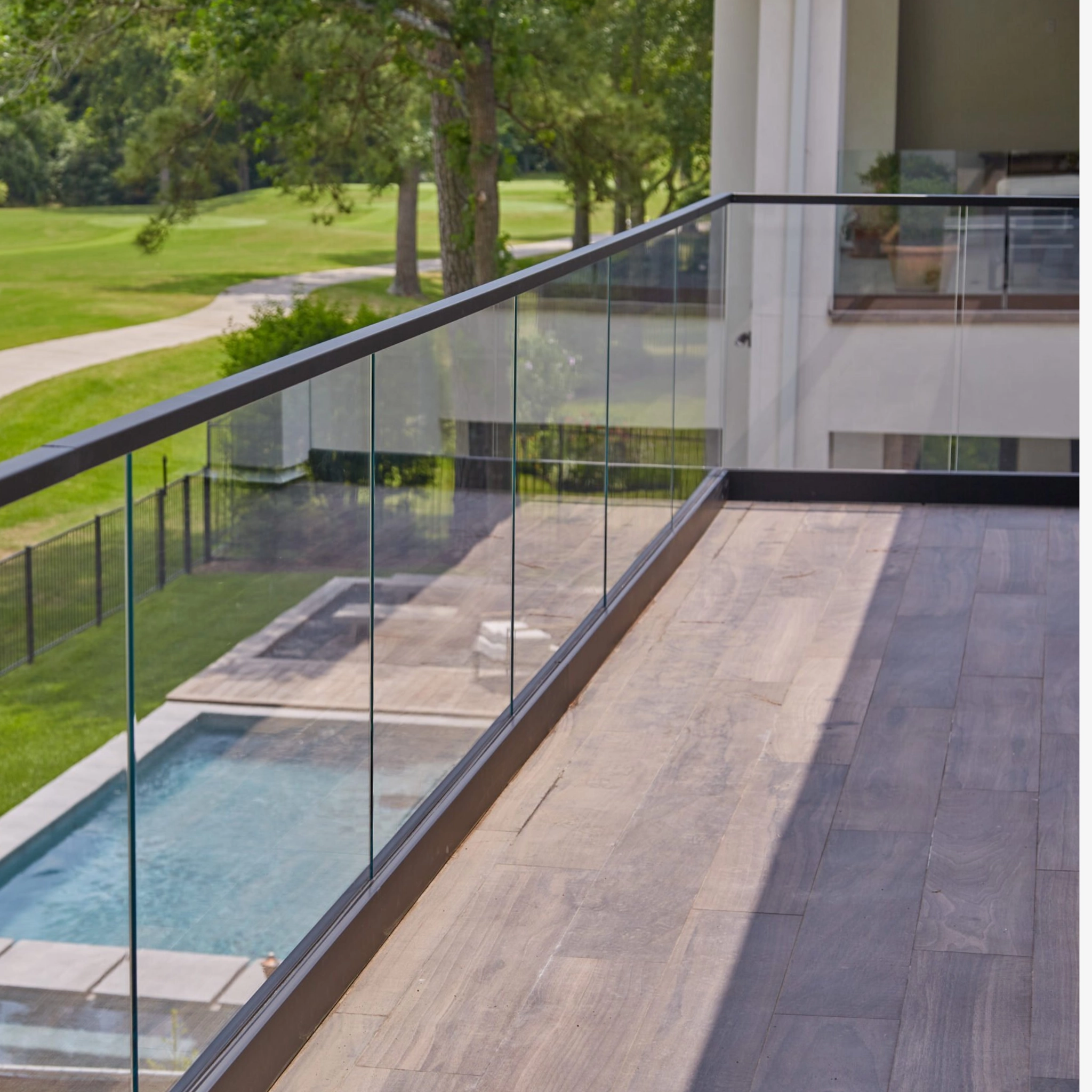 Base Rail on an outdoor balcony overlooking a pool and golf course.
